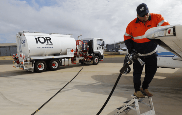 IOR Aviation staff wearing high-vis on step ladder refuelling Jet fuel into plane from IOR tanker