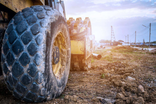 Yellow soil compaction machine on construction work site fuelled by premium diesel from IOR Petroleum.